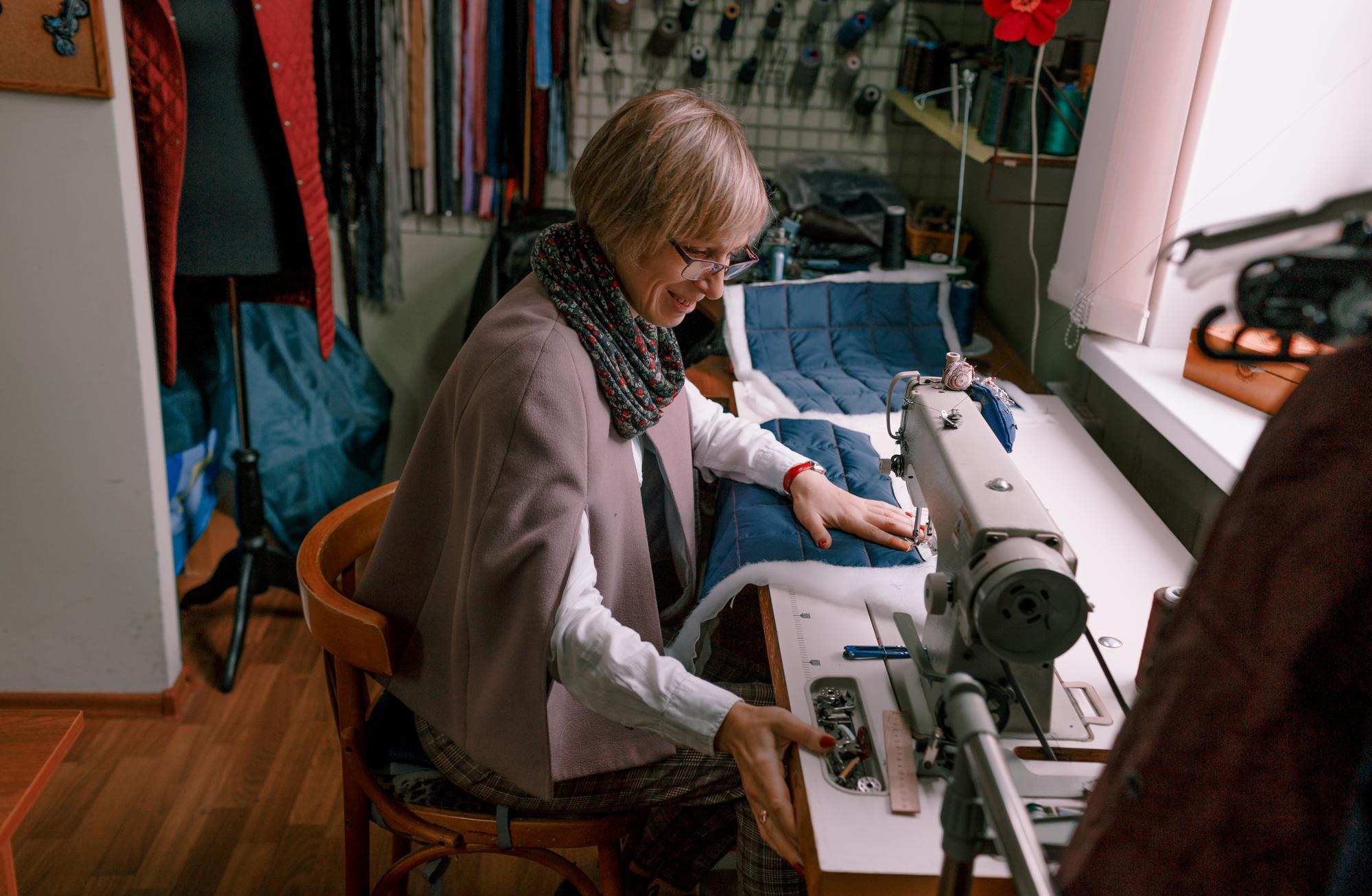 Technician preparing embroidery machine in modern workshop