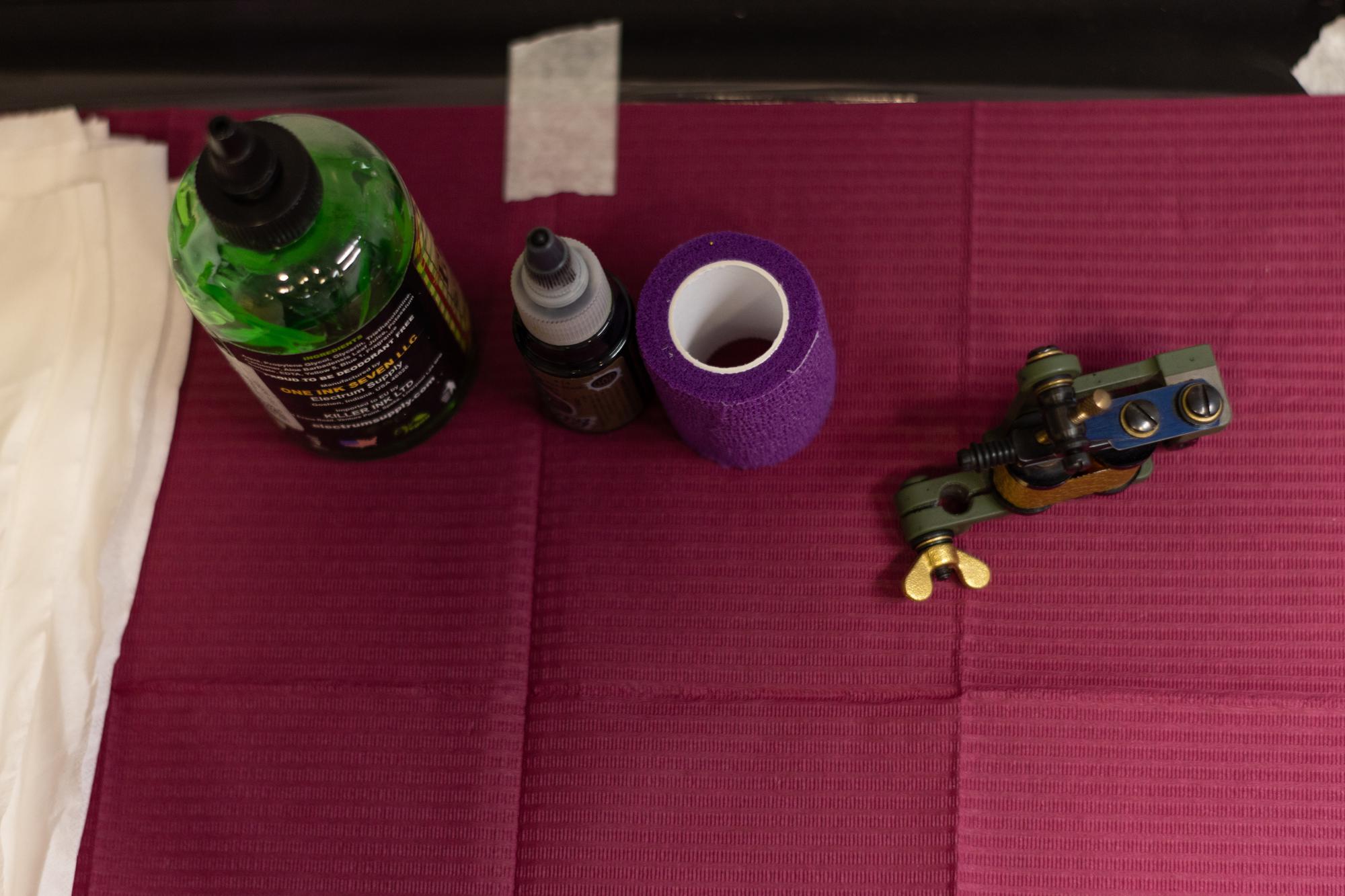 Stacked embroidered samples on a dark table